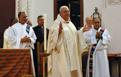 Father Arturo Miguel Ocampo, pastor of St. Patrick Parish in Indianapolis, was the principal celebrant for the fifth annual archdiocesan celebration of the feast of St. Martin de Porres on Nov. 3 at St. Patrick Church in Indianapolis. Concelebrants from Indianapolis parishes were Father Kenneth Taylor, pastor of Holy Angels Parish; Father Steven Schwab, pastor of St. Thomas Aquinas Parish; and Franciscan Father Thomas Fox, Hispanic ministry assistant for the archdiocese, who is in residence at Sacred Heart of Jesus Parish. Deacon Emilio Ferrer-Soto, left, and Deacon Oscar Morales, right, assisted with the multicultural liturgy. Rev. Samuel Ruiz, a Lutheran minister standing behind Father Ocampo, was a special guest at the liturgy. (Photo by Mary Ann Wyand) 