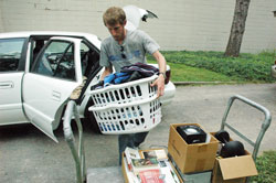 Archdiocesan seminarian Daniel Bedel, a senior at Bishop Simon Bruté College Seminary in Indianapolis, unloads his car on Aug. 13 at the seminary. Many of the 23 seminarians at Bishop Bruté moved in that day while construction workers made renovations to add 10 additional bedrooms to the seminary. (Photo by Sean Gallagher)