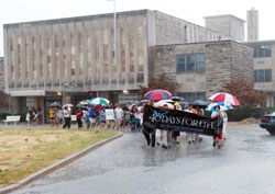 Determined pro-life supporters brave heavy rain as they begin the more than two-mile march from the St. Augustine Home for the Aged Chapel in Indianapolis to the Planned Parenthood abortion facility on Sept. 19 following the “40 Days for Life” opening prayer rally. (Submitted photo/Daniel Roy)