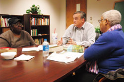 Deacon candidate Brad Anderson, center, leads a Rite of Christian Initiation of Adults (RCIA) class on Dec. 9 at Holy Angels Parish in Indianapolis. Listening to Anderson are, from left, RCIA candidates Marie House and Moe Edwards. (Photo by Sean Gallagher)