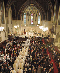 Priests, seminarians and members of Catholic fraternal organizations process into St. John the Evangelist Church at the start of the ordination Mass for Bishop Christopher J. Coyne on March 2, 2011. In the days leading up to Super Bowl XLVI on Feb. 5 at Lucas Oil Stadium in Indianapolis, St. John parishioners will serve as volunteer tour guides, known as “St. John evangelists,” to explain the history and religious significance of the architecture and other aspects of the parish’s historic church. (File photo by John Shaughnessy)