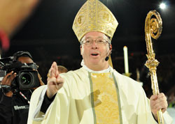 Bishop Christopher J. Coyne, apostolic administrator, blesses National Catholic Youth Conference and National Catholic Collegiate Conference participants on Nov. 19, 2011, at Lucas Oil Stadium in Indianapolis at the end of the closing liturgy. He was the principal celebrant at the Mass and the host for the 31st biennial conference, which was sponsored by the National Federation for Catholic Youth Ministry. The conference brought more than 23,000 youths and young adults to Indianapolis to celebrate their Catholic faith. (File photo by Mary Ann Garber)