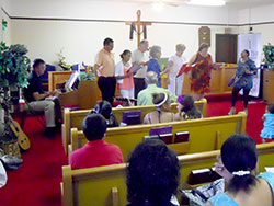 Members of the bilingual choir at St. Joseph Parish in Corydon sing during the 170th anniversary service of St. Paul African Methodist Episcopal (AME) Church, also located in Corydon, on July 21. (Photo by Patricia Happel Cornwell)