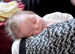 Cooper Featherling, 12-weeks-old, is held by a member of Annunciation Parish in Brazil. Cooper’s mother, Lindsay Featherling, also of Annunciation Parish, brought her infant son to the Sanctity of Life Dinner on March 6 in Indianapolis. (Photo by Natalie Hoefer)