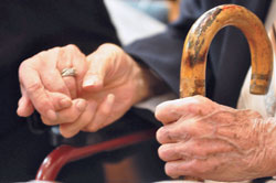 A couple holds hands during the Golden Wedding Jubilee Mass at SS. Peter and Paul Cathedral in Indianapolis on Sept. 21, 2014. The growing number of marriages in the archdiocese lasting 50 or more years—plus the desire to recognize all marriages—led the archdiocesan Office of Pro Life and Family Life to focus the annual Golden Wedding Jubilee Mass on those celebrating their 50th anniversary, and a separate Mass to honor all married couples, with special recognition given to those married for 60 or more years. (File photo by Natalie Hoefer)