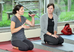 Colleen Scariano, right, listens as Deanne Miller explains the concept of SoulCore to approximately 30 women who came to Our Lady of Fatima Retreat House in Indianapolis on April 29 to learn about the rosary-based, core-strengthening exercise and the story of how it was developed. Scariano and Miller are the creators of SoulCore. (Photo by Natalie Hoefer)