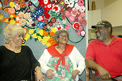 The joy is contagious as Madeline Bonds, left, and Berton Graves share a memory and a laugh with their mother, Dorothy Porter, during time together at A Caring Place. The Catholic Charities Indianapolis program is marking its 25th year of providing day care services for older adults, and a daily respite for their caregivers. (Photo by John Shaughnessy)