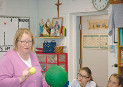 Her inquisitive nature—and her deep belief in the beautiful design of the world that God has created—serve Leah Massingale well as she teaches science to middle-school students at St. Michael School in Greenfield. (Photo by John Shaughnessy) 