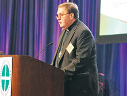 Cardinal Joseph W. Tobin of Newark, N.J., addresses the national conference of U.S. bishops during their annual spring assembly in Indianapolis on June 14. (Photo by Sean Gallagher)	