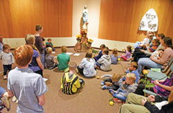 Children and their parents gather before a statue of Mary on Oct. 7, the feast of Our Lady of the Rosary, to pray the rosary in the daily Mass chapel of St. Matthew the Apostle Parish in Indianapolis. (Photo by Sean Gallagher)