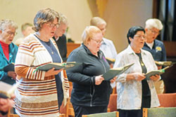 Benedictine Sister Susan Nicole Reuber, left, Benedictine Sister Heather Jean Foltz and Benedictine Sister Rocio Moreno pray Evening Prayer on Oct. 16 in the chapel of Our Lady of Grace Monastery in Beech Grove. (Photo by Sean Gallagher)