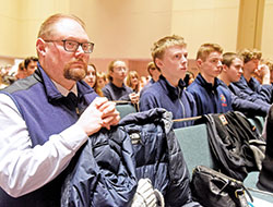 Brian Greer, right, principal of Lumen Christi Catholic High School in Indianapolis, kneels in prayer with students from the school on Jan. 22 in the Indiana Convention Center in Indianapolis during a Mass celebrated prior to the Indiana March for Life. (Photo by Sean Gallagher)