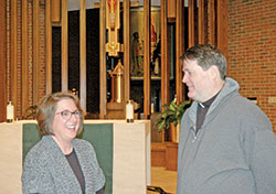 Maria Harr poses for a photo with Father Robert Hankee, the pastor of Christ the King Parish in Indianapolis. The faith community of Christ the King Parish has been a blessing for Harr in her journey from brokenness to beauty. (Photo by John Shaughnessy)