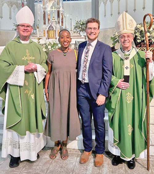 Lafayette, Ind., Bishop Timothy L. Doherty, left, Angela Espada, Alexander Mingus and Indianapolis Archbishop Charles C. Thompson pose for a photo in St. John the Evangelist Church in Indianapolis after a July 23 Mass for the annual summer meeting of the National Association of State Catholic Conference Directors. (Submitted photo)