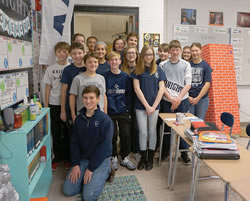 Eighth-grade students in teacher Tori Hart’s “10:10” class at Central Catholic Junior-Senior High School participated in the custom of “chalking of the doors” for the feast of the Epiphany. The students used blessed chalk to write above the doorway to their classroom. (Photo by Caroline B. Mooney)