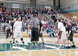 Priests and seminarians of the Lafayette diocese prepare for the tip-off of the second annual “Cassock Classic,” held Jan. 2 before a crowd of nearly 700 at Westfield High School. The seminarians team came away with the win for the second straight year in the event organized by the Frassati Society of Young Adult Catholics. (Photo by Brigid Curtis Ayer)